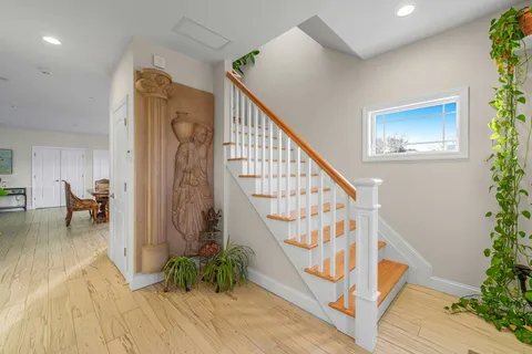 a view of entryway with wooden floor and stairs