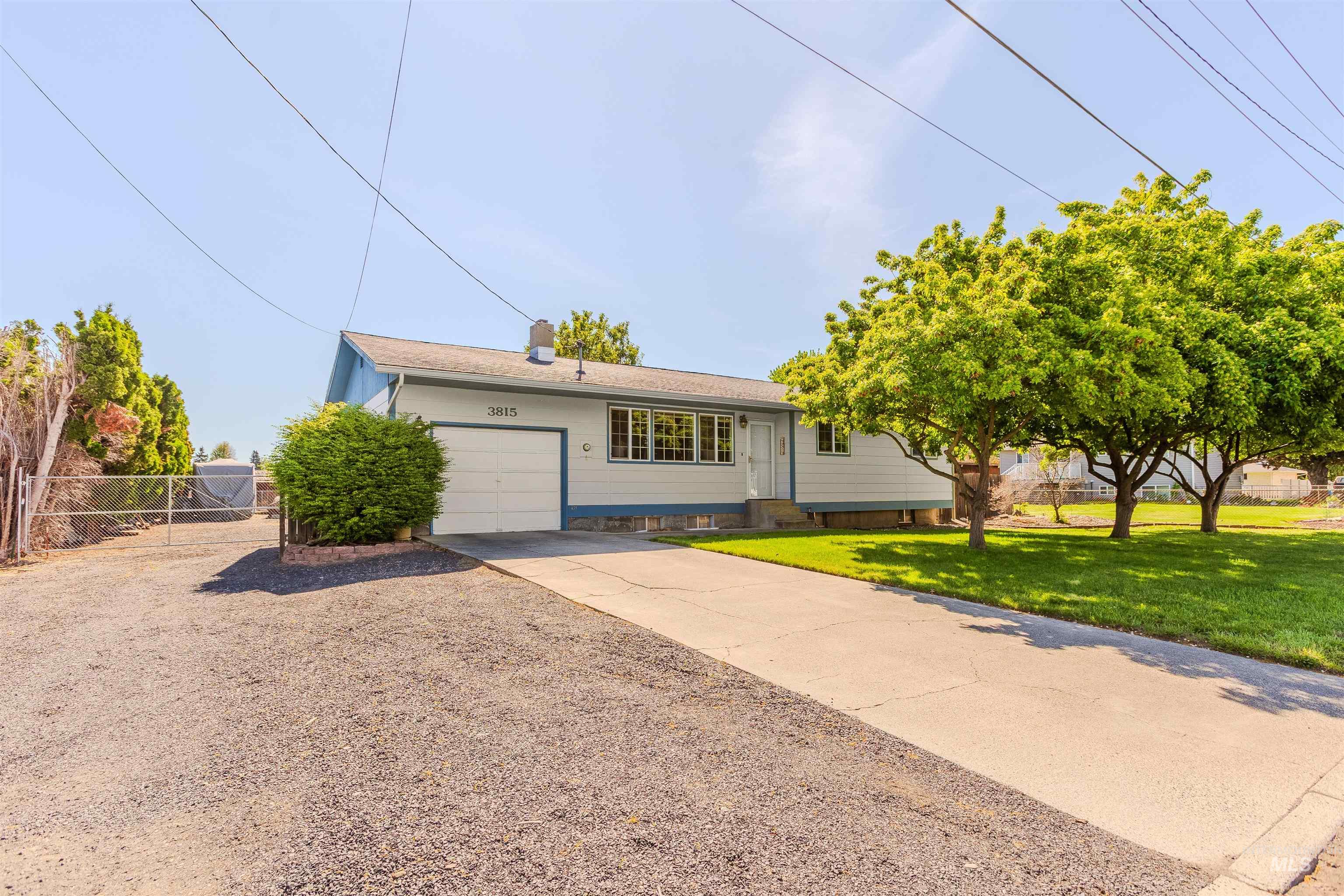 Ranch-style house with concrete driveway and a garage