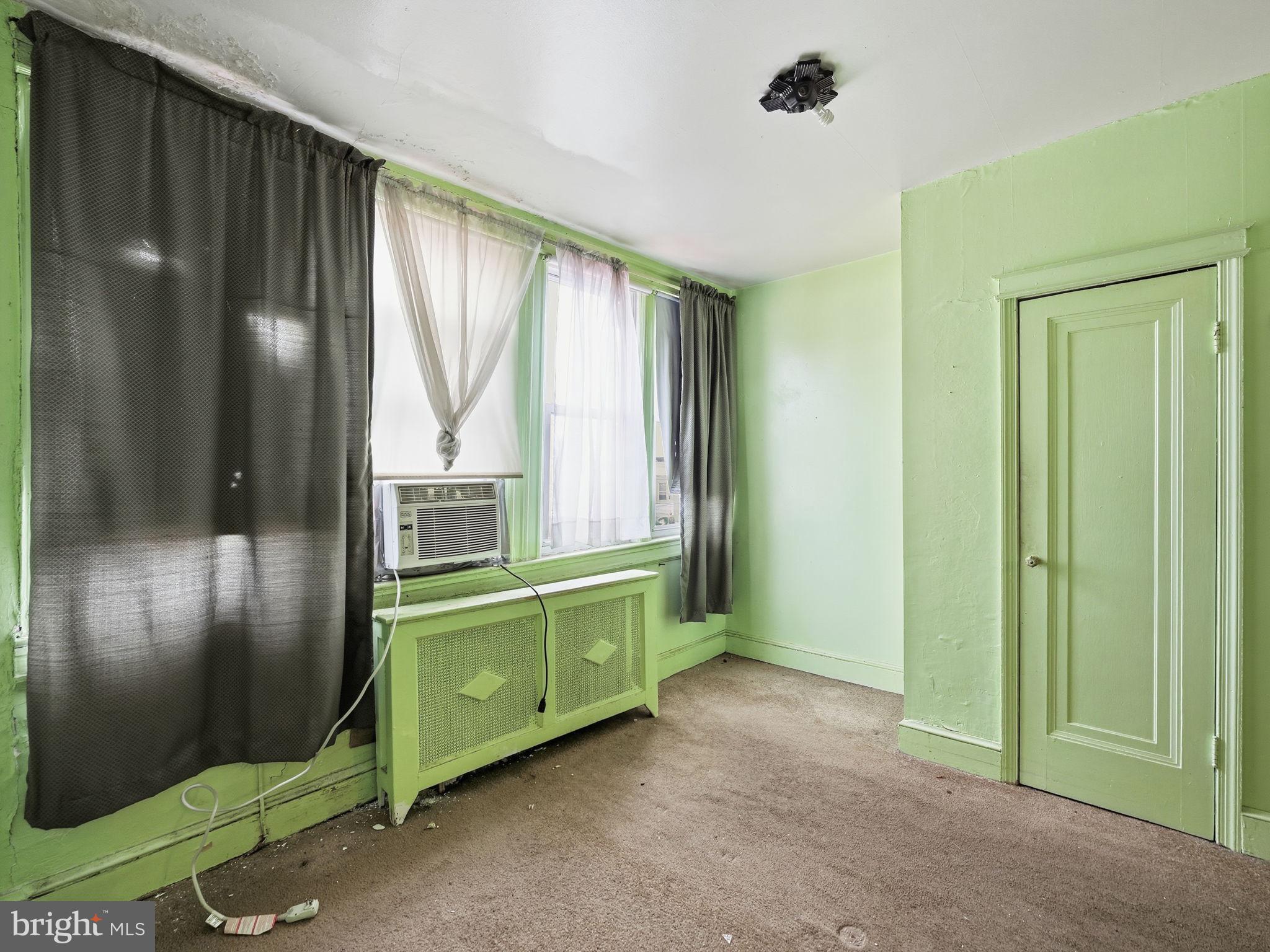 5733 9th Street Northwest Washington, DC 20011 - Photo 6 of 20 a room with a green plant and a large window