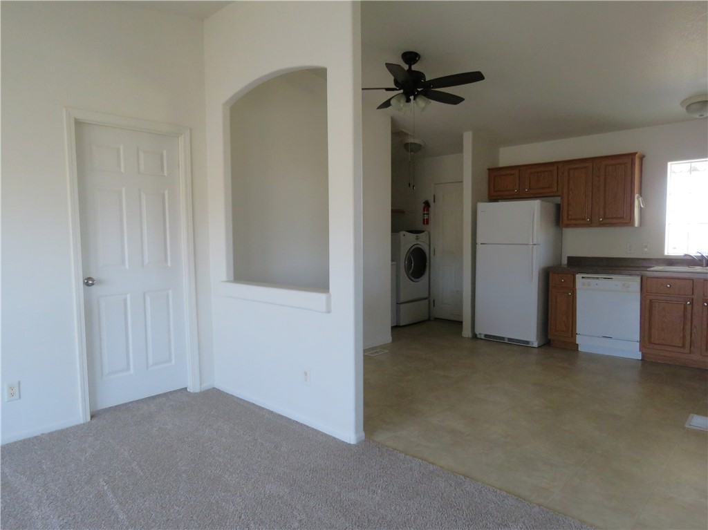 785 Bacobi Road Golden Valley, AZ 86413 - Photo 13 of 35 an empty room with a ceiling fan and a hallway