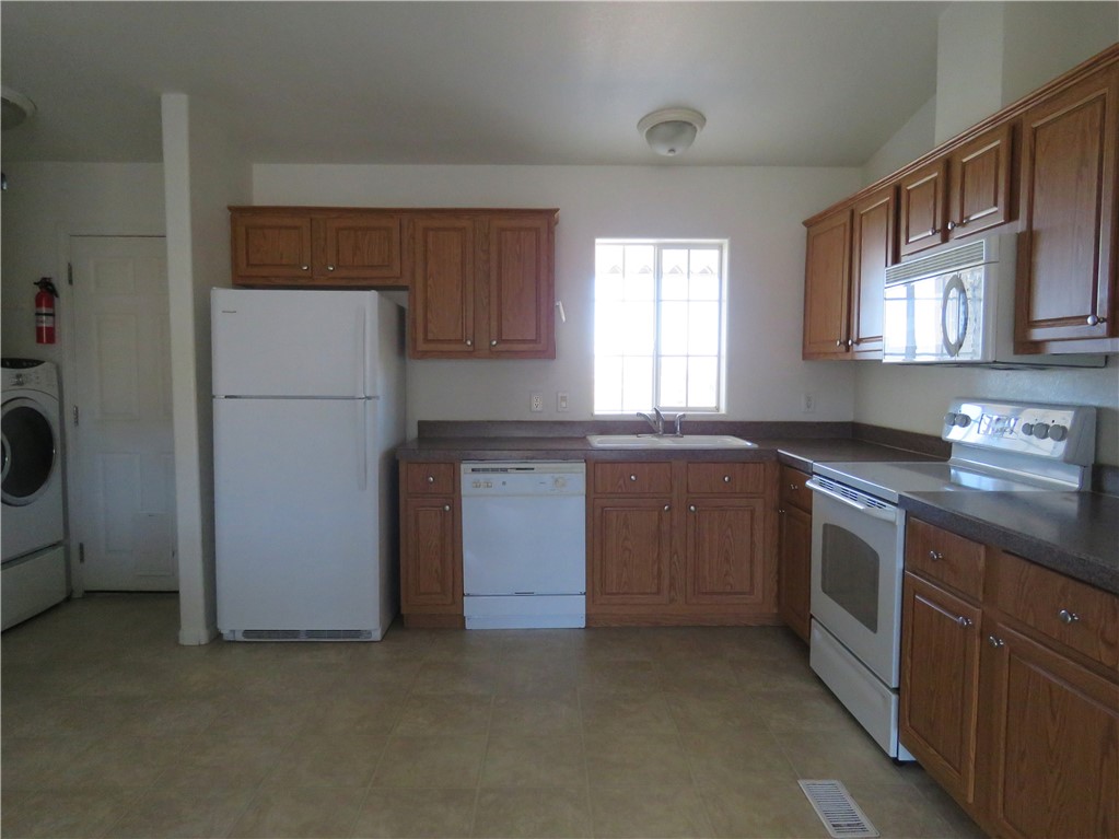785 Bacobi Road Golden Valley, AZ 86413 - Photo 14 of 35 a kitchen with a sink stove and refrigerator