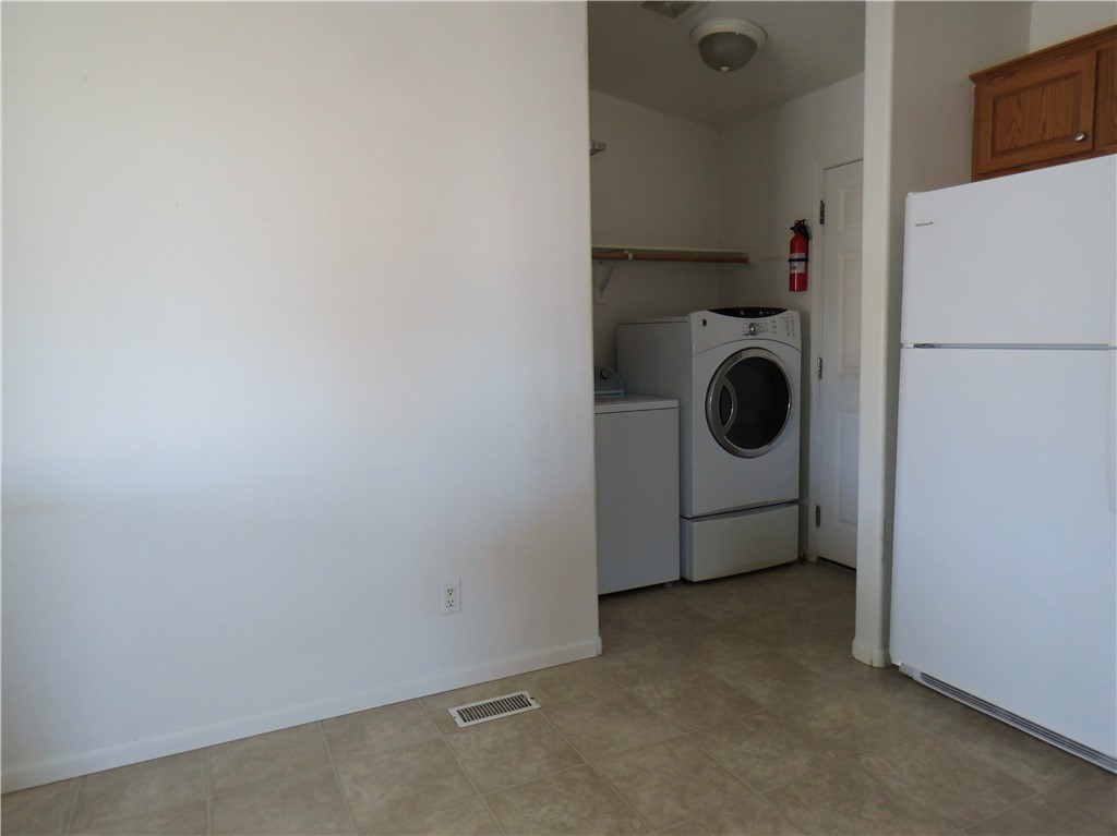 785 Bacobi Road Golden Valley, AZ 86413 - Photo 15 of 35 a utility room with dryer and washer