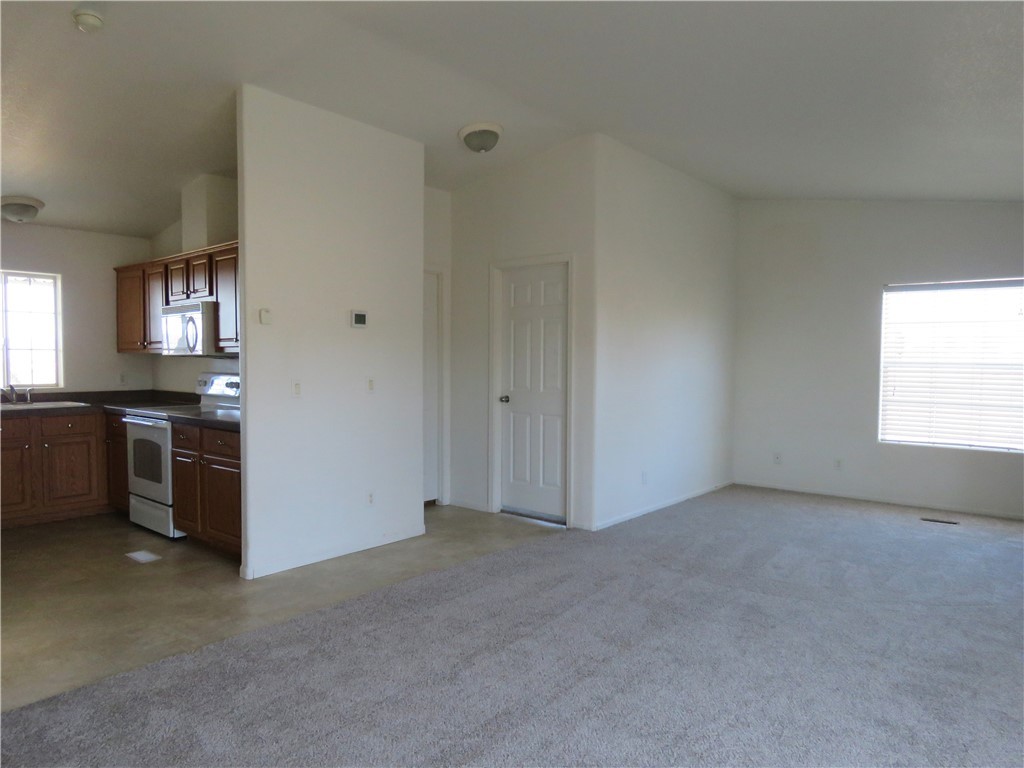 785 Bacobi Road Golden Valley, AZ 86413 - Photo 26 of 35 a view of an empty room with a kitchen