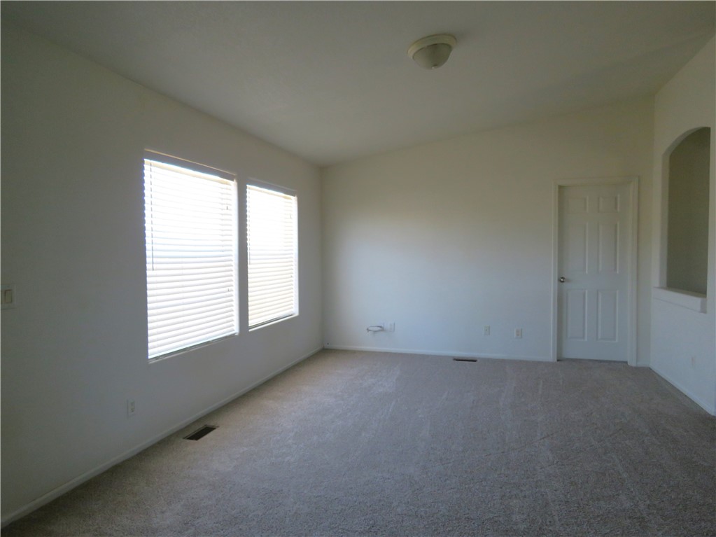 785 Bacobi Road Golden Valley, AZ 86413 - Photo 3 of 35 an empty room with a window