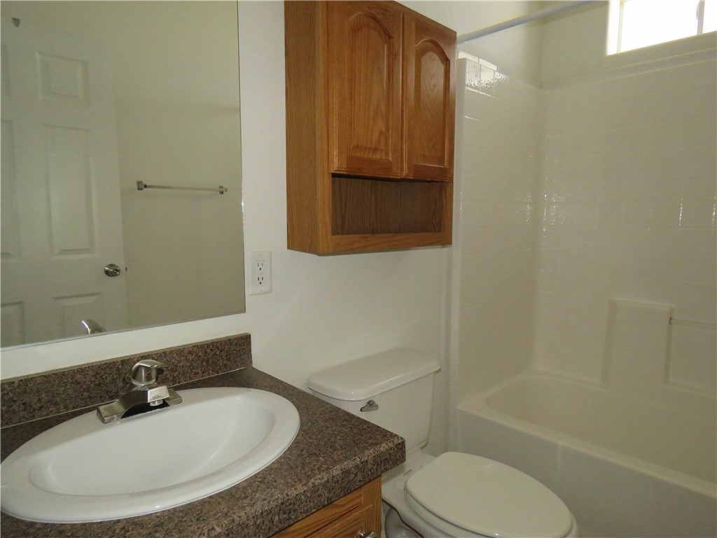 785 Bacobi Road Golden Valley, AZ 86413 - Photo 32 of 35 a bathroom with a granite countertop sink toilet and shower