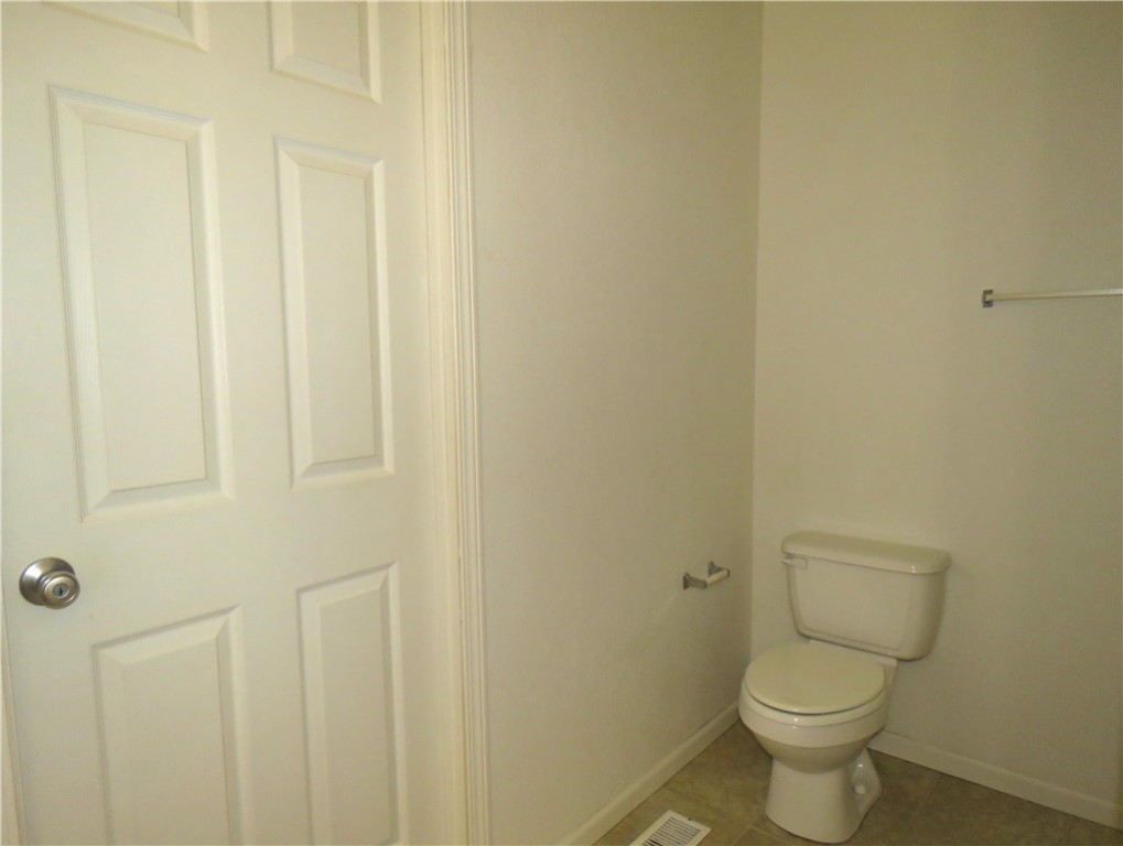 785 Bacobi Road Golden Valley, AZ 86413 - Photo 9 of 35 a white toilet sitting next to a white wall