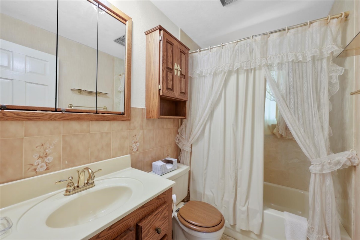 12 Circle Drive Decatur, IL 62521 - Photo 9 of 35 a bathroom with a sink a toilet and shower curtain