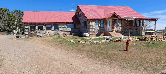 a view of a house with backyard porch and sitting area