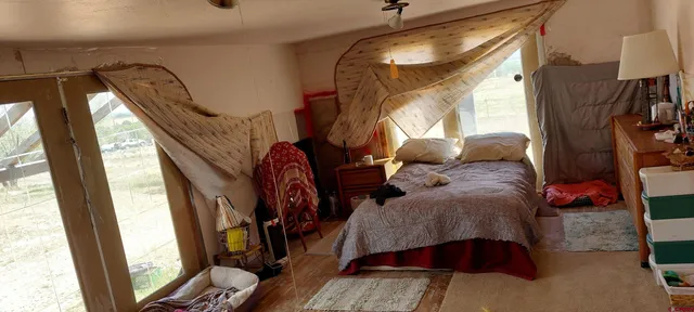 a view of a hallway with furniture and a window