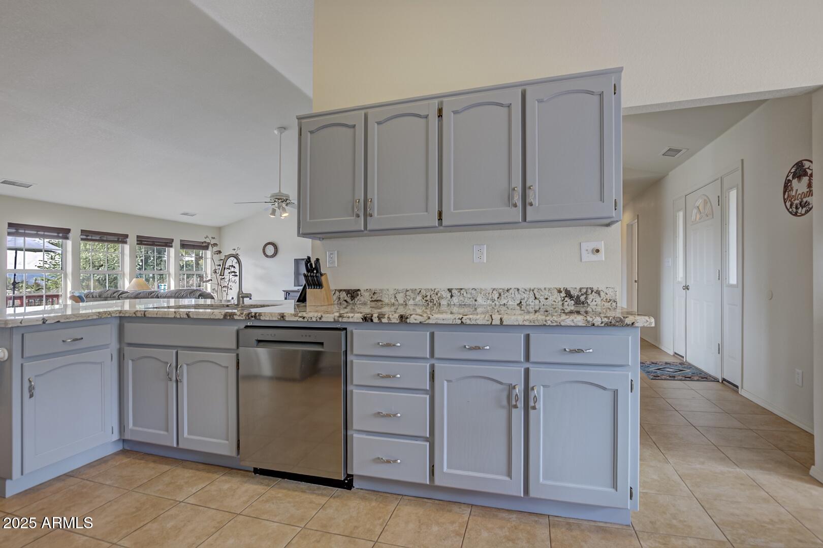 155 Claxton Road Payson, AZ 85541 - Photo 12 of 46 a kitchen with white cabinets granite counter tops and a stove