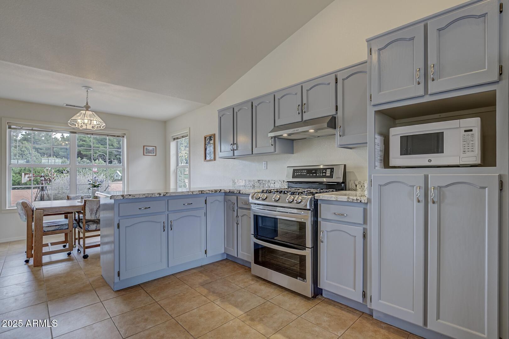 155 Claxton Road Payson, AZ 85541 - Photo 10 of 46 a kitchen with stainless steel appliances granite countertop a stove and a refrigerator