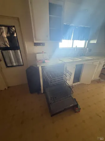 a room with a sink a washer and dryer