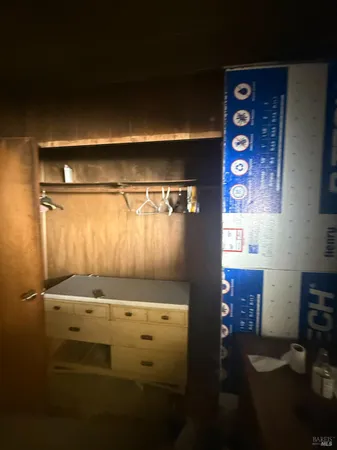 a view of a hallway with wooden shelves