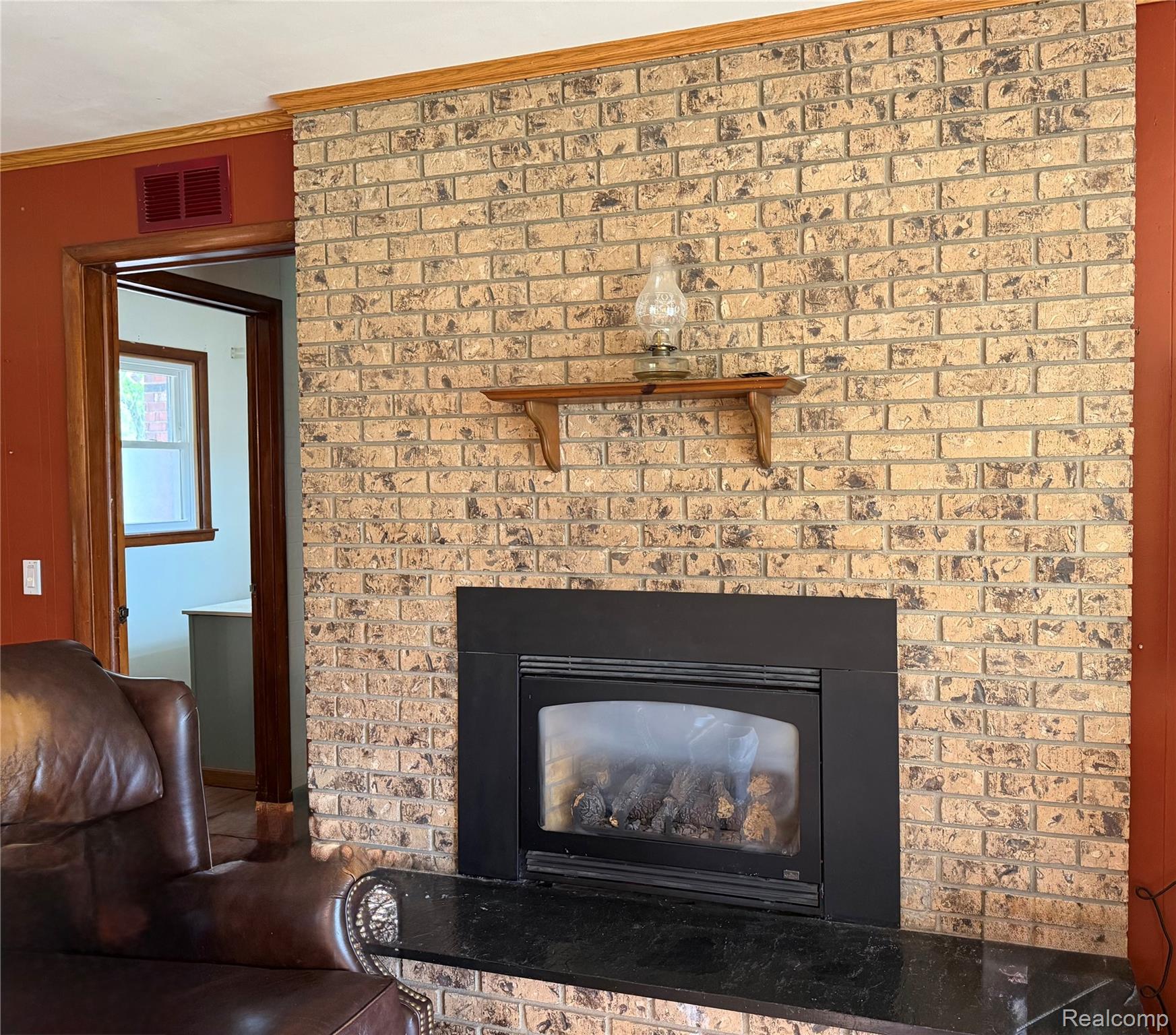 1412 South Byron Road Lennon, MI 48449 - Photo 7 of 22 Detailed view of crown molding and a brick fireplace