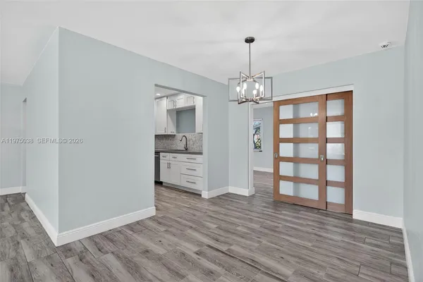 a view of a room with wooden floor and window