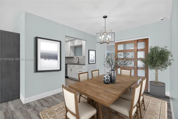 a dining room with wooden floor a chandelier a wooden table and chairs