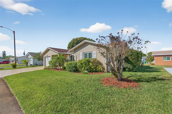 a view of a house with a yard and plants