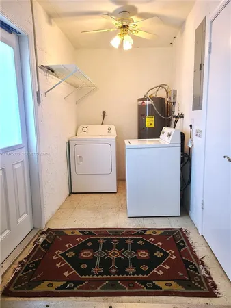 a room with water heater and a wooden floor