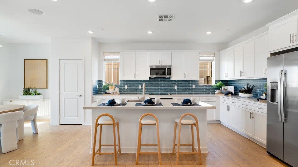 1625 Eagle Road Rialto, CA 92376 - Photo 1 of 23 a kitchen with stainless steel appliances granite countertop a stove a sink a refrigerator a dining table and chairs