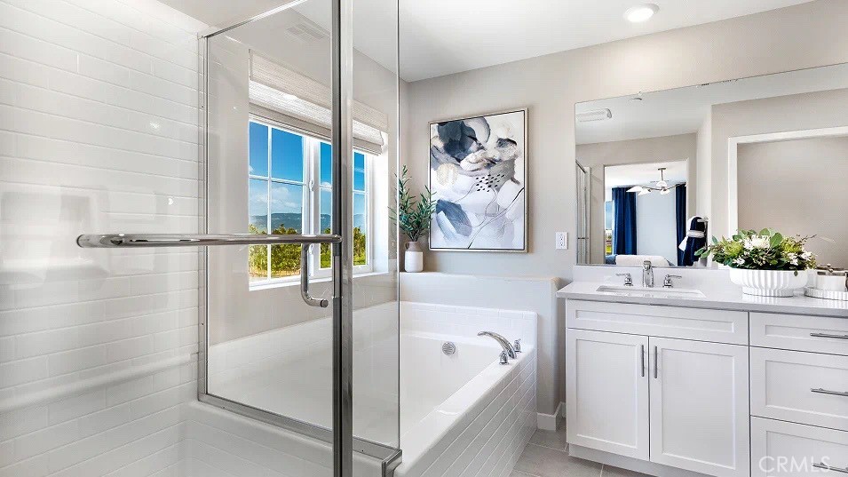 1625 Eagle Road Rialto, CA 92376 - Photo 16 of 23 a spacious bathroom with a tub sink and mirror