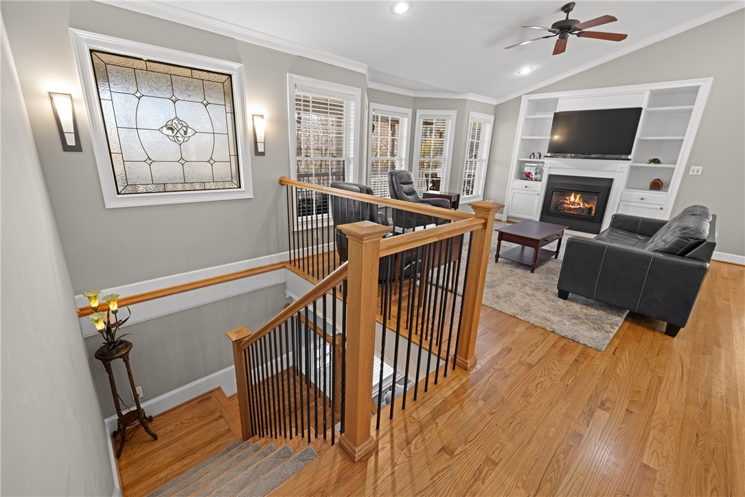 204 Riverlake Road Fair Play, SC 29643 - Photo 31 of 50 This inviting living space features an elegant fireplace, vaulted ceilings, and rich hardwood flooring.
