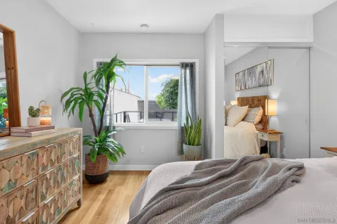 a bedroom with a bed and a potted plant