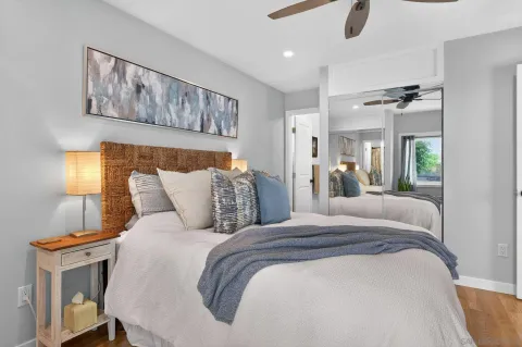 a bed room with a bed and a painting on the wall