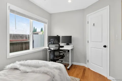 a view of a workspace with furniture and a window