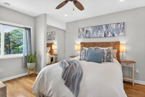 a bed sitting in a bedroom next to a window