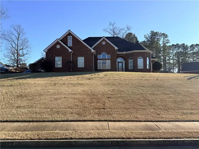 a front view of a house with a yard