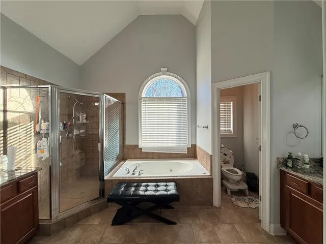 a bathroom with a tub sink and mirror