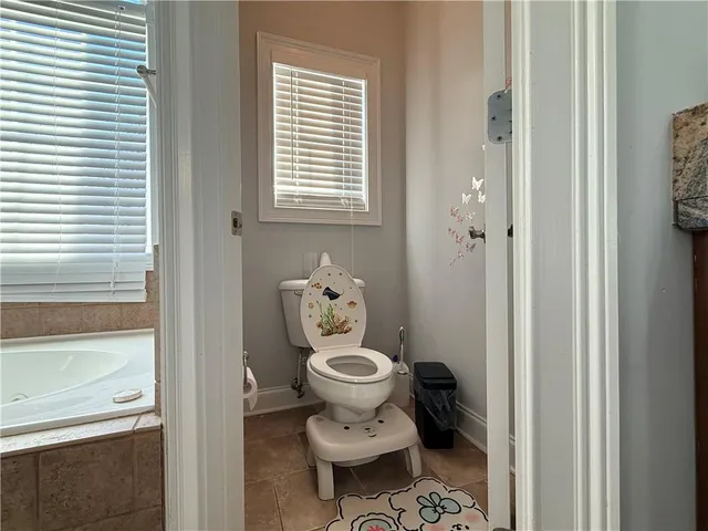 a view of a dining room with furniture a chandelier and wooden floor