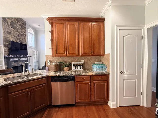 a kitchen with stainless steel appliances granite countertop a stove sink microwave and refrigerator