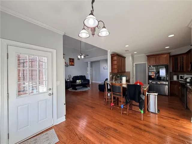 a dining room with furniture and wooden floor