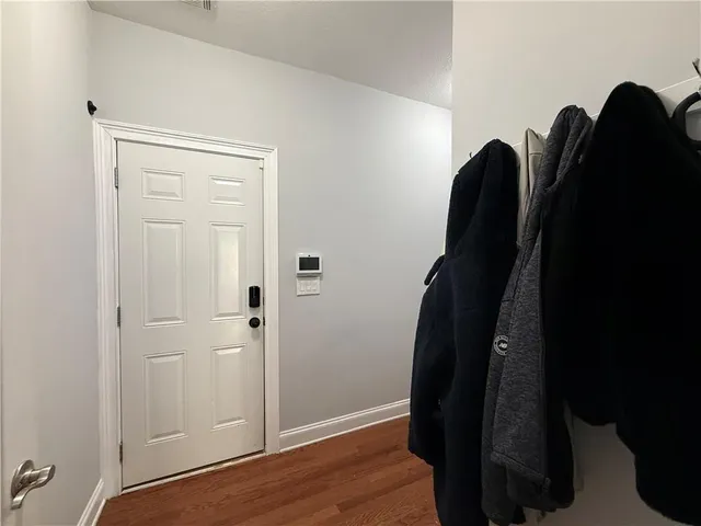 a view of hallway with wooden floor