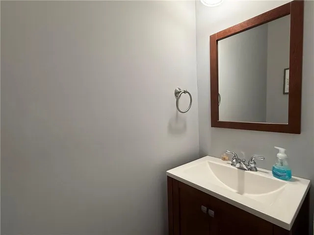 a bathroom with a sink a stove and cabinets