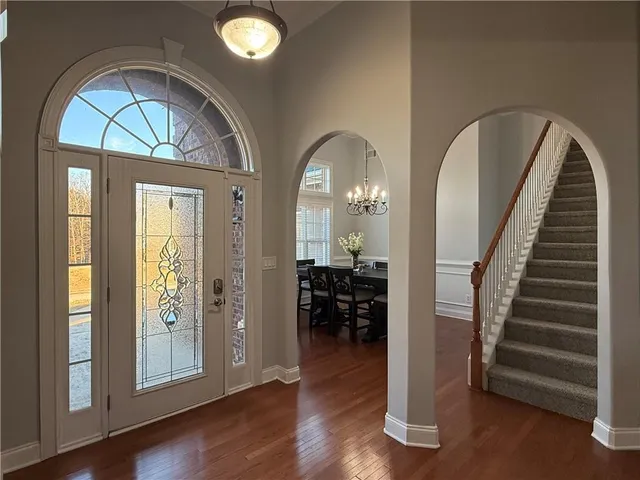 a living room with furniture chandelier and a fireplace