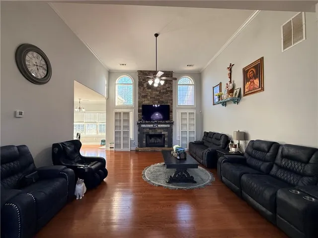 a living room with furniture a fireplace and a table