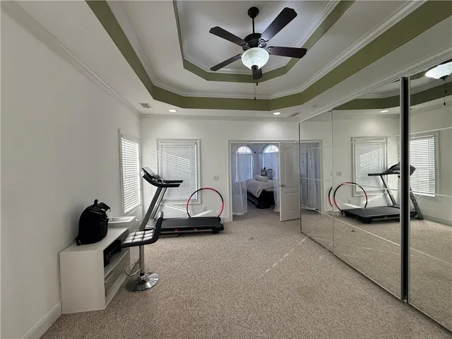 a bedroom with bed and a chandelier