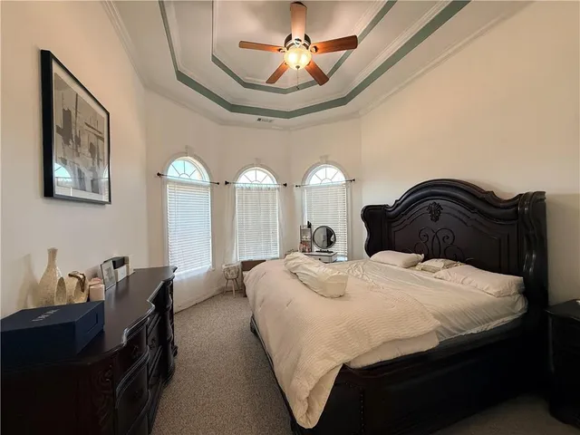a bedroom with a bed and a chandelier