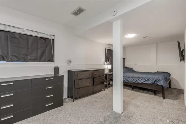 a bedroom with a bed and a dresser