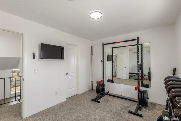 a view of a livingroom with furniture and a flat screen tv