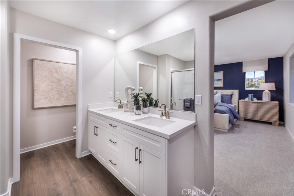 9535 Silverstein Drive Riverside, CA 92508 - Photo 7 of 11 a spacious bathroom with a double vanity sink and mirror