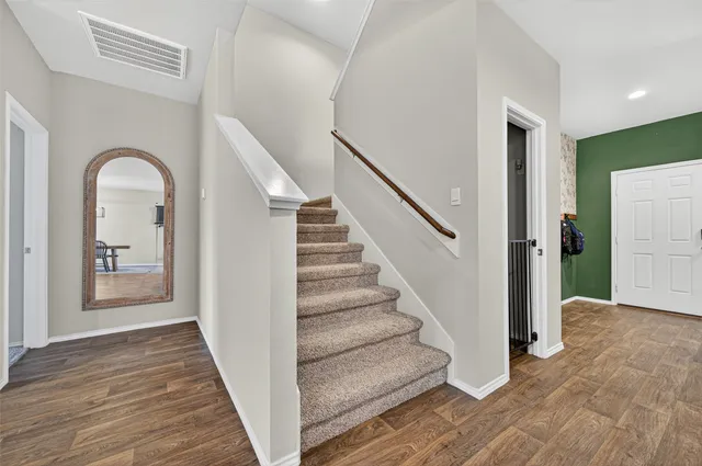 a view of a room with furniture and a flat screen tv