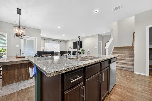 a living room with a bed and wooden floor