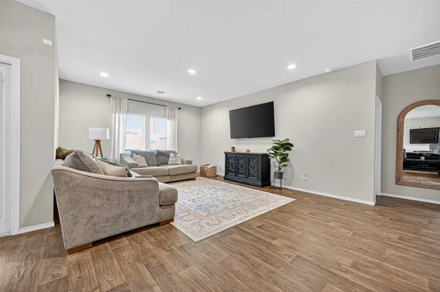 a kitchen with stainless steel appliances granite countertop a stove top oven a sink dishwasher and cabinets with wooden floor