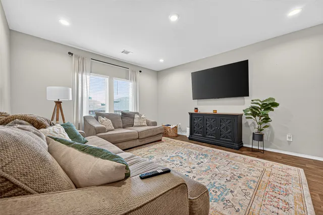 a kitchen with stainless steel appliances a table chairs refrigerator microwave and cabinets