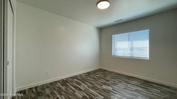 a view of a room with wooden floor and window