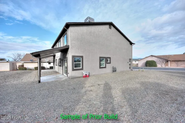 a view of a house with backyard and a garage