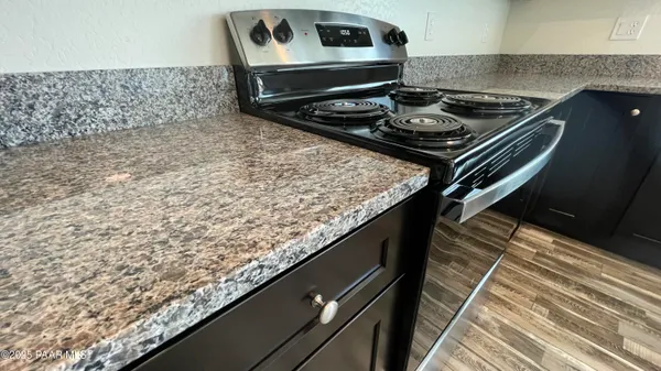 a stove top oven sitting inside of a kitchen